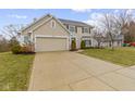 Charming home featuring a spacious driveway, attached two-car garage, and a well-manicured front lawn at 7591 Meadow Ridge Dr, Fishers, IN 46038
