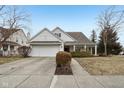 Charming home featuring a well-manicured lawn, attached garage, and a welcoming front porch at 780 Pawtucket Dr, Westfield, IN 46074