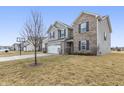 Inviting two-story home with a well-maintained lawn, mature tree, and a two-car garage at 8193 Cagles Mill Trce, Avon, IN 46123
