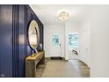 Inviting entryway with stylish console table, accent mirror and modern lighting at 9434 Abner St, McCordsville, IN 46055