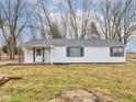Well-maintained single-story house featuring dark-framed windows and a freshly painted exterior at 9909 N 125 W, Fortville, IN 46040