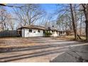An updated one-story home featuring a long driveway surrounded by mature trees at 1020 E 51St St, Indianapolis, IN 46205