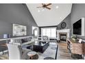 Cozy living room with high ceilings, fireplace, and natural light, perfect for relaxing and entertaining guests at 10896 Fairwoods Dr, Fishers, IN 46037