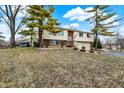 Two-story home with two car garage and mature trees on an early spring day at 1218 W Shady Creek Dr, Greenwood, IN 46142