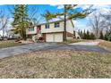 Two-story home with two car garage and mature trees on an early spring day at 1218 W Shady Creek Dr, Greenwood, IN 46142