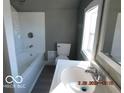 Functional bathroom showcasing a tub, toilet, and well-lit sink area at 1311 E Hines St, Muncie, IN 47303