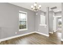 Bright living room with hardwood floors, neutral paint, a modern light fixture, and large windows at 14474 Treasure Creek Ln, Fishers, IN 46038