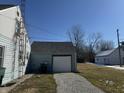 Detached garage with ample parking space and gravel driveway at 1624 S Jersey Ave, Muncie, IN 47302