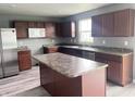 Kitchen featuring stainless steel appliances, dark cabinets, and an island at 215 Traditions Pass, Greenwood, IN 46143