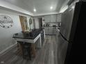 Updated kitchen with stainless steel appliances, central island, and grey cabinetry at 326 W State Road 42, Mooresville, IN 46158