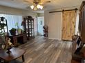 Open living space with updated flooring, sliding barn door, and plenty of room for entertaining guests at 326 W State Road 42, Mooresville, IN 46158