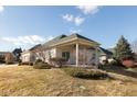 View of the home's backyard and covered porch that has a swing to relax on at 3387 Nottinghill W Dr, Plainfield, IN 46168