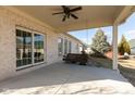 Covered porch featuring a relaxing swing and views of the home's backyard at 3387 Nottinghill W Dr, Plainfield, IN 46168