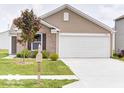 Beautifully maintained home with an attached garage and a well-kept lawn at 3693 Berkdale Dr, Columbus, IN 47203