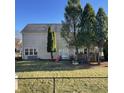 Fenced backyard with lawn, sliding glass doors, a wood deck, and mature trees for privacy at 5124 Deer Creek Ct, Indianapolis, IN 46254