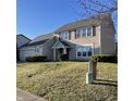Well-maintained two-story home with attached garage, lush lawn, and traditional architectural details at 5124 Deer Creek Ct, Indianapolis, IN 46254