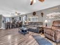 Open concept living room flows into kitchen featuring modern flooring, neutral walls, and comfortable seating at 6905 Percy Dr, Indianapolis, IN 46113