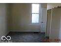 Comfortable bedroom featuring carpet flooring and ample natural light from the window at 711 W Centennial Ave, Muncie, IN 47303
