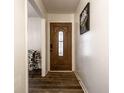 Welcoming entryway with a hardwood front door and decorative glass inlay, complemented by wood floors at 7671 Sherry Ln, Brownsburg, IN 46112