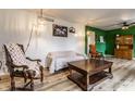 Inviting living room featuring wood-look floors and stylish decor and bright, contrasting green wall at 7671 Sherry Ln, Brownsburg, IN 46112