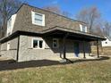 This beautiful home features stone accents, a covered porch, and a well-maintained lawn at 8468 N Baltimore Rd, Monrovia, IN 46157
