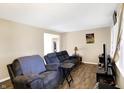 Inviting living room with comfortable seating, modern flooring, and plenty of natural light from a nearby window at 8525 Edith St, Martinsville, IN 46151