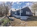 A view of the home's back exterior with a deck and serene landscaping at 10556 Marlin Ct, Indianapolis, IN 46256