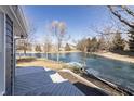 Outdoor space featuring a wooden deck overlooking a tranquil pond and neighboring houses at 10556 Marlin Ct, Indianapolis, IN 46256