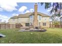 Spacious backyard with a patio, deck, and privacy fence, ideal for outdoor entertaining at 10560 Power Dr, Carmel, IN 46033