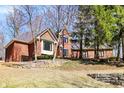 Charming brick home with a stone retaining wall, mature trees, and well-maintained landscaping at 11850 Deer Walk Dr, Cicero, IN 46034