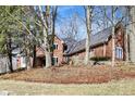 Brick home nestled among mature trees with a lush lawn, showcasing curb appeal at 11850 Deer Walk Dr, Cicero, IN 46034