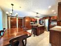Large kitchen and dining area with wood cabinets, stainless steel appliances, island with seating at 1285 W Judson Ln, Mooresville, IN 46158