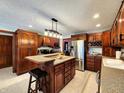 Spacious kitchen with dark wood cabinets, stainless steel appliances, and granite countertops at 1285 W Judson Ln, Mooresville, IN 46158