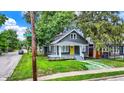A charming house with a well-manicured lawn on a tree lined street corner at 1304 N Tuxedo St, Indianapolis, IN 46201