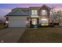 Charming two-story home with a brick and siding exterior, complemented by a well-manicured lawn and landscaping at 14126 Secretariat Ct, Carmel, IN 46074