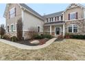An inviting exterior view showcasing the well-maintained landscaping and architectural details of the home at 14466 Integrity Ct, Carmel, IN 46033