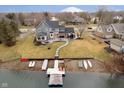 Backyard featuring a large patio, with a path to the lake, boat dock and watercraft at 14809 Adios Pass, Carmel, IN 46032
