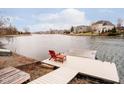 Dock with a comfortable chair and table, perfect for enjoying the lake view at 14809 Adios Pass, Carmel, IN 46032