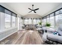 Bright sun room with large windows, neutral decor, and a ceiling fan at 14809 Adios Pass, Carmel, IN 46032