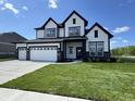 Beautiful new construction home featuring a three car garage and lush lawn at 15871 Vitalize Run, Fishers, IN 46040