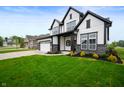 Attractive two-story home with green lawn and manicured landscape along sidewalk in a suburban neighborhood at 15871 Vitalize Run, Fishers, IN 46040