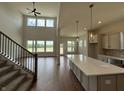 Open-concept living area with soaring ceilings and large windows, perfect for entertaining at 15871 Vitalize Run, Fishers, IN 46040