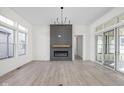 Bright living room featuring a sleek fireplace, modern lighting, and sliding glass doors at 17364 Pinellas Ave, Westfield, IN 46074