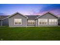 Spacious backyard with a lush green lawn, complemented by gray siding and windows at 19568 Astoria Ave, Sheridan, IN 46069