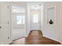 Bright entryway with wood flooring, a white door, and an open view to the living area at 19568 Astoria Ave, Sheridan, IN 46069