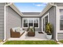 Cozy patio with wicker furniture, surrounded by gray siding and bright windows at 19568 Astoria Ave, Sheridan, IN 46069