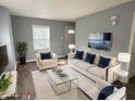 Bright living room with modern furnishings, neutral walls, and hardwood floors at 2001 Glenridge Dr, Indianapolis, IN 46218
