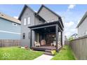 Backyard featuring a covered patio, seating, and a well-maintained lawn perfect for outdoor enjoyment at 2026 Alvord St, Indianapolis, IN 46202