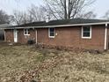 The backyard of this house is a spacious and private area with a well-maintained lawn and mature trees at 2032 Costello Dr, Anderson, IN 46011