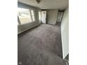 Open living room featuring new carpet, fresh paint, and ample natural light at 2032 Costello Dr, Anderson, IN 46011